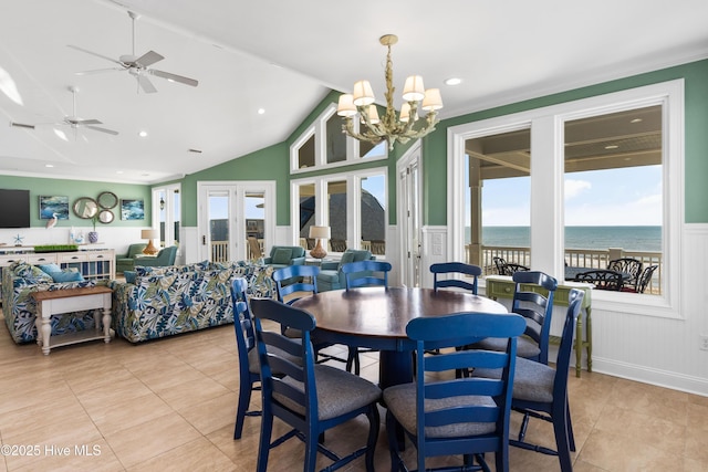 dining room with a chandelier, light tile patterned floors, wainscoting, a water view, and french doors