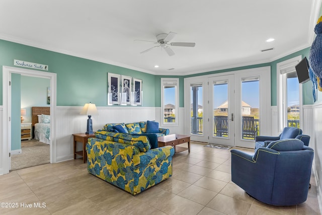 living area featuring ceiling fan, wainscoting, tile patterned flooring, ornamental molding, and recessed lighting
