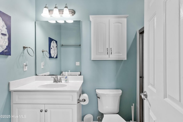bathroom with toilet and vanity