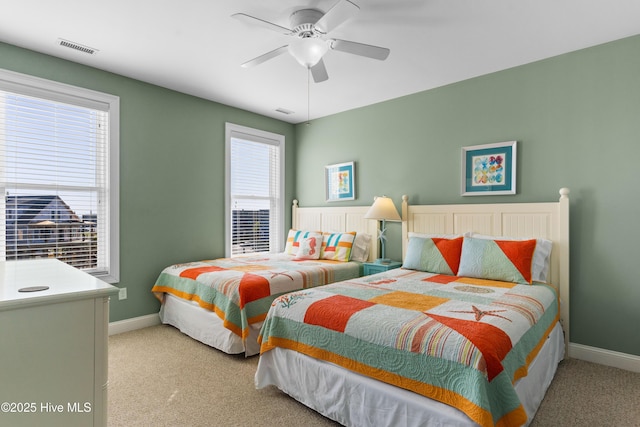 bedroom with carpet, baseboards, and a ceiling fan