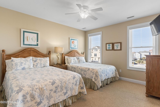 bedroom with baseboards, light carpet, and ceiling fan