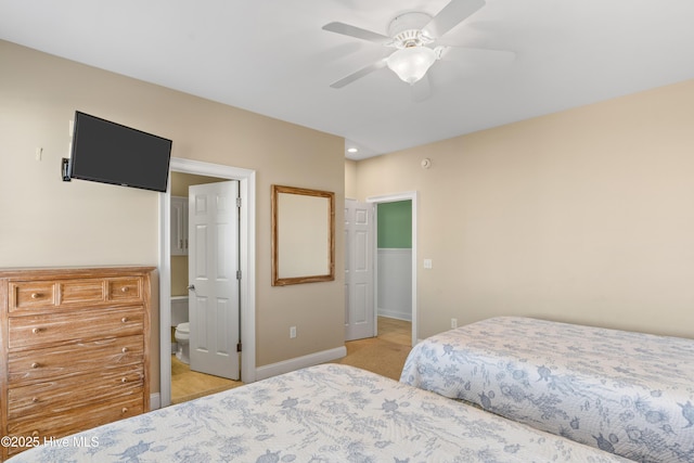 bedroom featuring baseboards, ceiling fan, and light colored carpet