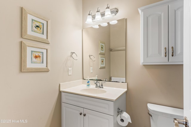 half bathroom featuring toilet and vanity