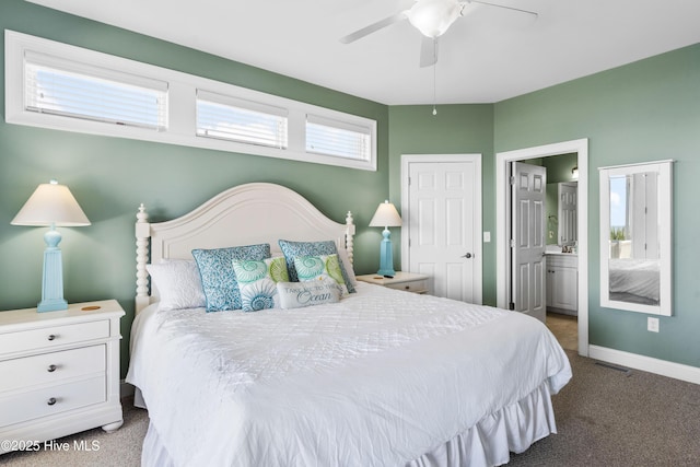 carpeted bedroom featuring ensuite bathroom, baseboards, and a ceiling fan