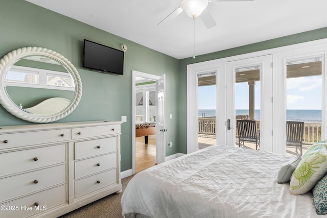bedroom with access to outside, baseboards, and light colored carpet