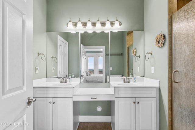 bathroom featuring ensuite bath, two vanities, and an enclosed shower