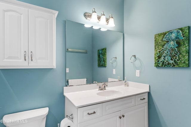 half bathroom featuring toilet and vanity