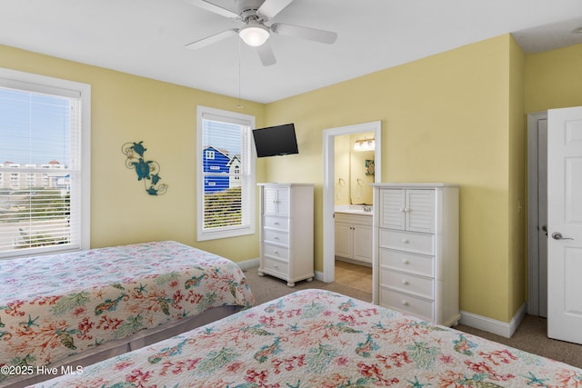 bedroom featuring carpet floors, multiple windows, and baseboards