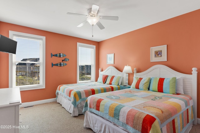 carpeted bedroom with baseboards and ceiling fan