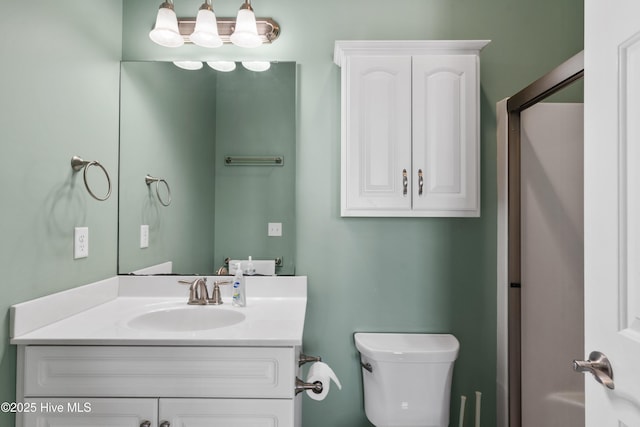 bathroom featuring toilet and vanity