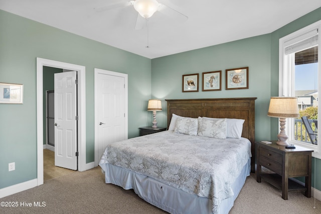 carpeted bedroom with baseboards and a ceiling fan