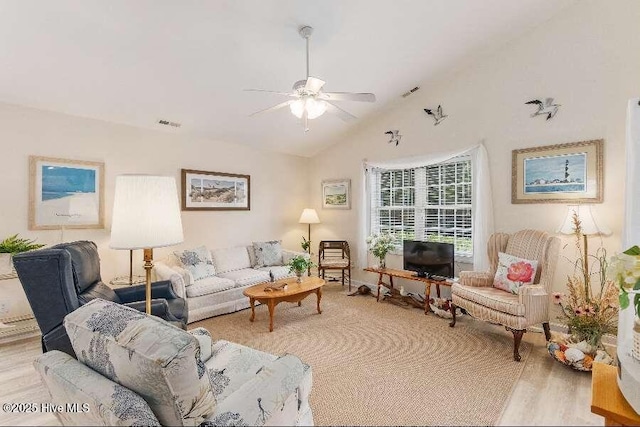 living room featuring ceiling fan, vaulted ceiling, and wood finished floors
