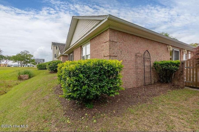 view of side of home with brick siding