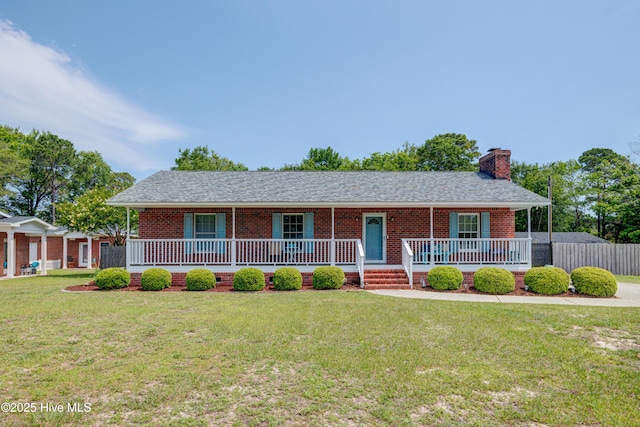 138 Cherokee Trl, Wilmington, NC 28409 - ranch-style home with a porch, a chimney, brick siding, and roof with shingles