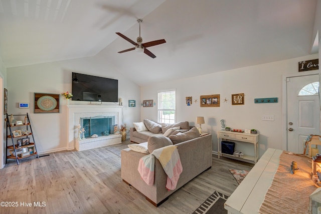138 Cherokee Trl, Wilmington, NC 28409 - living room featuring ceiling fan, wood finished floors, vaulted ceiling, a brick fireplace, and baseboards