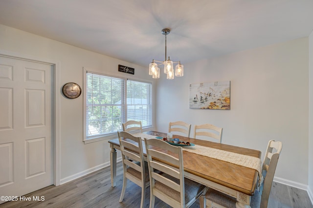 138 Cherokee Trl, Wilmington, NC 28409 - dining room featuring baseboards, wood finished floors, and a chandelier