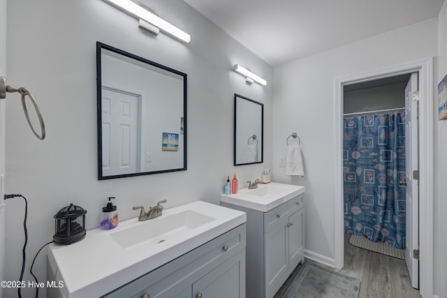 138 Cherokee Trl, Wilmington, NC 28409 - full bath featuring wood finished floors, two vanities, and baseboards