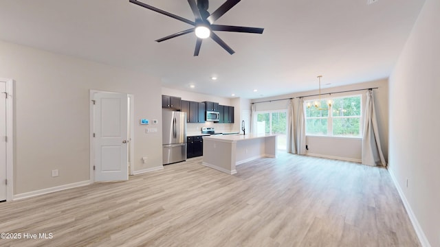 kitchen with stainless steel appliances, light wood-type flooring, light countertops, ceiling fan, and recessed lighting
