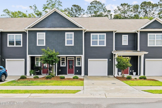 townhome / multi-family property featuring concrete driveway and a porch