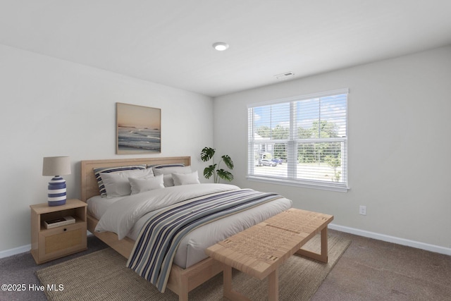 carpeted bedroom featuring baseboards