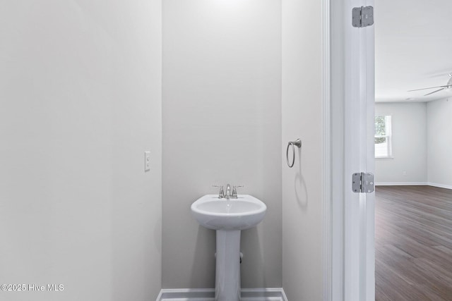 bathroom with baseboards, wood finished floors, and ceiling fan
