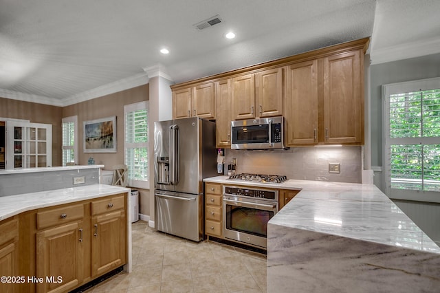1204 Pine Valley Rd, North Myrtle Beach, SC 29582 - kitchen featuring stainless steel appliances, crown molding, backsplash, light stone counters, and light tile patterned floors