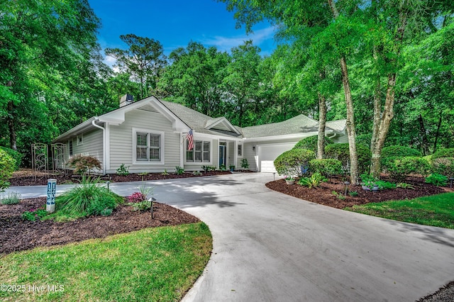 1204 Pine Valley Rd, North Myrtle Beach, SC 29582 - ranch-style house featuring an attached garage, a chimney, driveway, and view of scattered trees