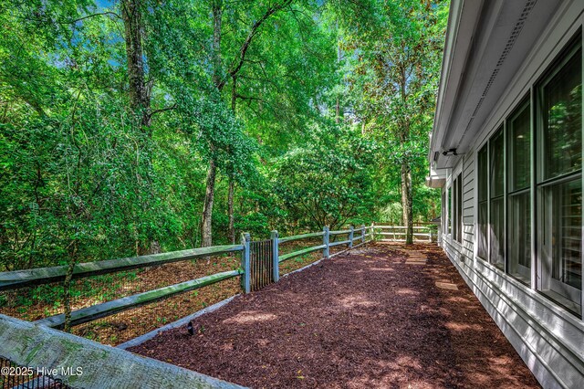 1204 Pine Valley Rd, North Myrtle Beach, SC 29582 - view of yard featuring fence and a forest view