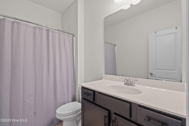 full bathroom featuring toilet and vanity