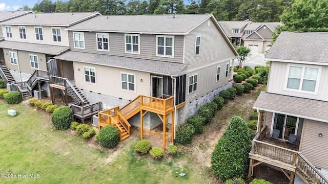 back of property featuring stairs, a wooden deck, a residential view, roof with shingles, and a yard