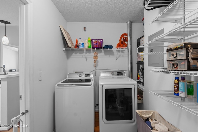 laundry room with independent washer and dryer and a textured ceiling