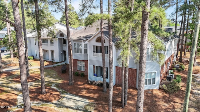 view of front of property with brick siding and cooling unit