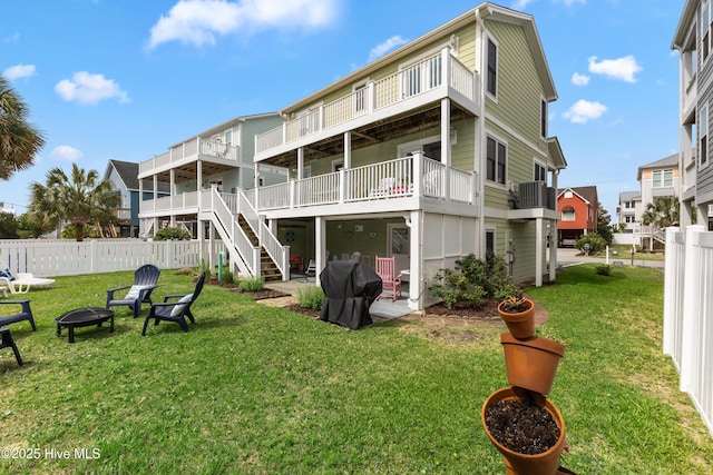 118 Clippership Dr, Holden Beach, NC 28462 - rear view of property featuring a fire pit, central AC unit, stairway, a patio, and a balcony