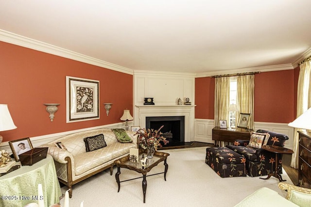 living room featuring ornamental molding, a fireplace, and wainscoting