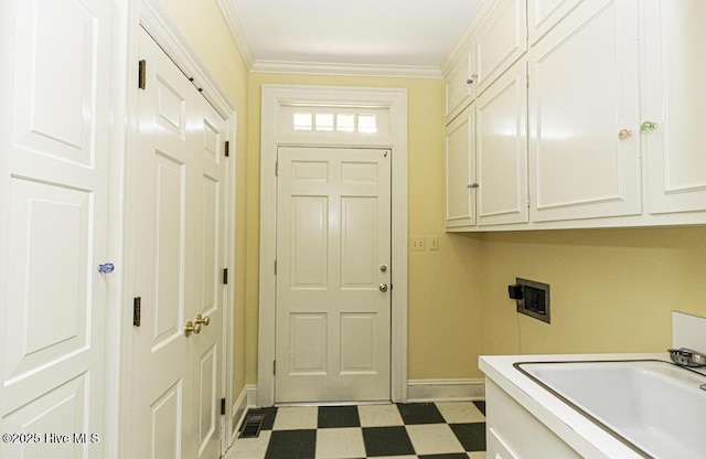 laundry room with cabinet space, tile patterned floors, hookup for a washing machine, baseboards, and crown molding