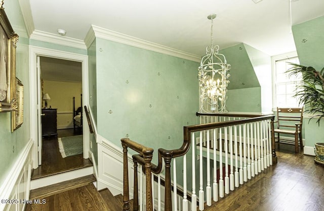 hall featuring an upstairs landing, dark wood-style floors, crown molding, and a chandelier