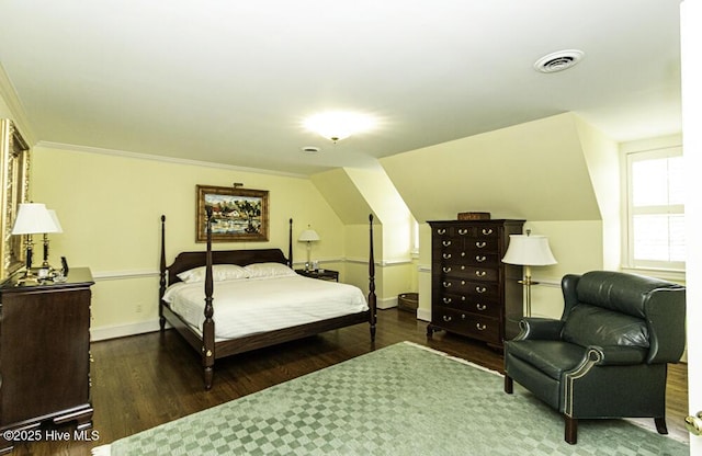 bedroom with wood finished floors, baseboards, lofted ceiling, and ornamental molding