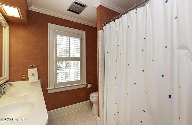 bathroom with baseboards, toilet, tile patterned floors, crown molding, and double vanity