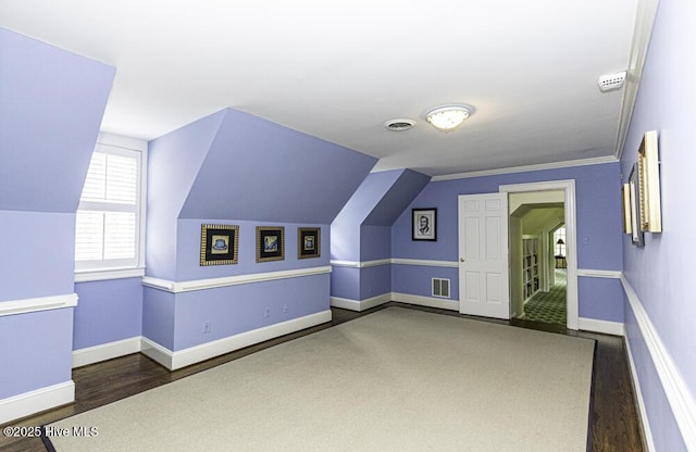 bonus room featuring wood finished floors, baseboards, and lofted ceiling
