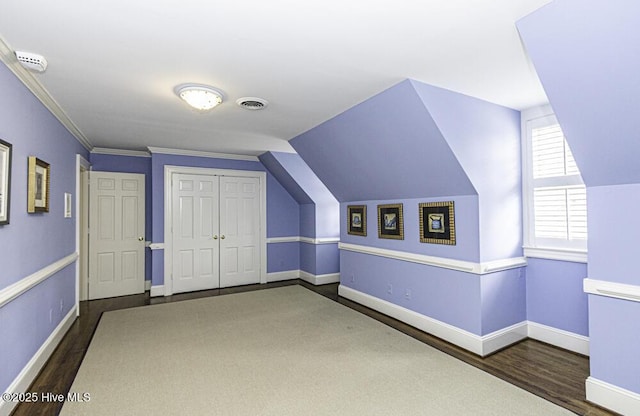bonus room with wood finished floors and baseboards