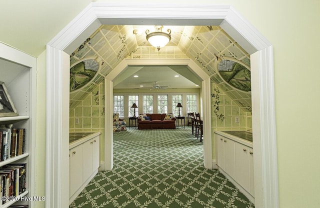 hallway featuring dark colored carpet