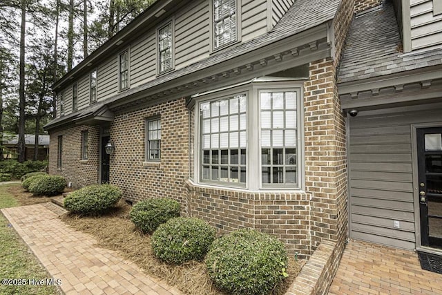 view of property exterior with brick siding