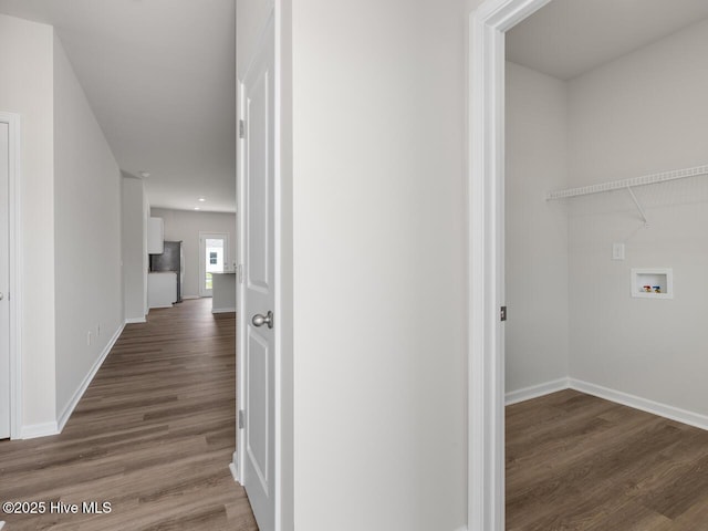 hall with wood finished floors and baseboards
