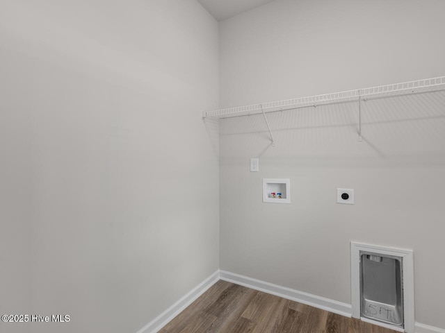 clothes washing area with hookup for an electric dryer, hookup for a washing machine, dark wood-style flooring, and baseboards
