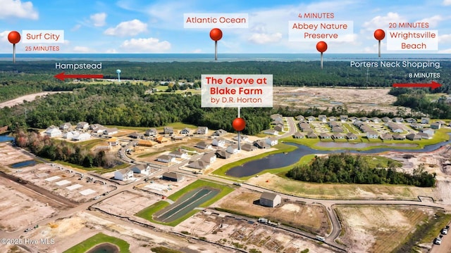 aerial view of residential area featuring a nearby body of water