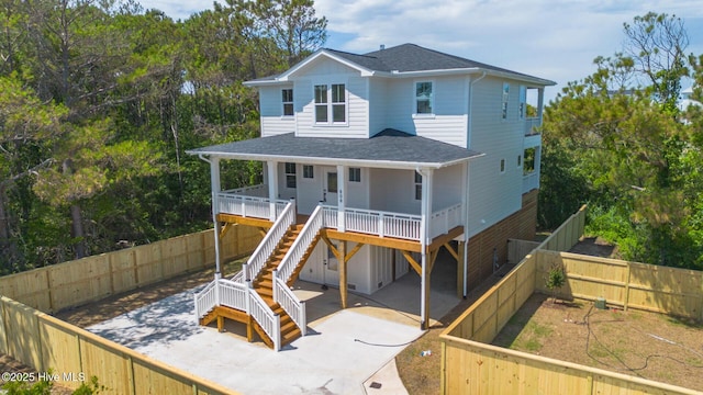 808 S 2nd St, Carolina Beach, NC 28428 - rear view of house with stairs, a patio, a fenced backyard, roof with shingles, and a porch