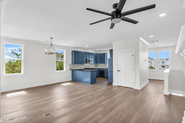 808 S 2nd St, Carolina Beach, NC 28428 - unfurnished living room with baseboards, recessed lighting, light wood-type flooring, a ceiling fan, and a chandelier