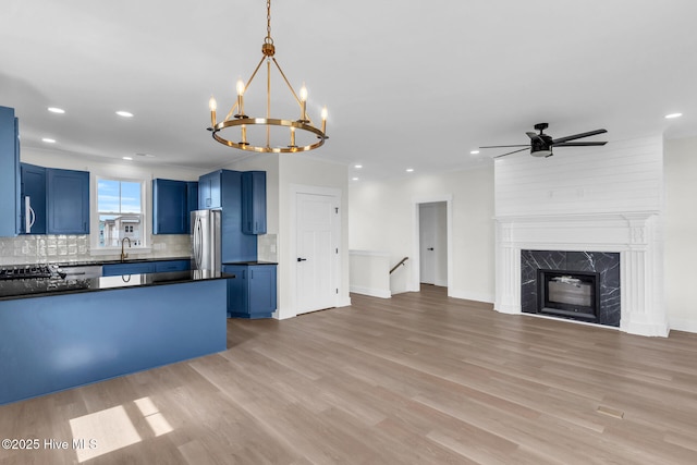 808 S 2nd St, Carolina Beach, NC 28428 - kitchen featuring blue cabinetry, appliances with stainless steel finishes, dark countertops, open floor plan, and recessed lighting