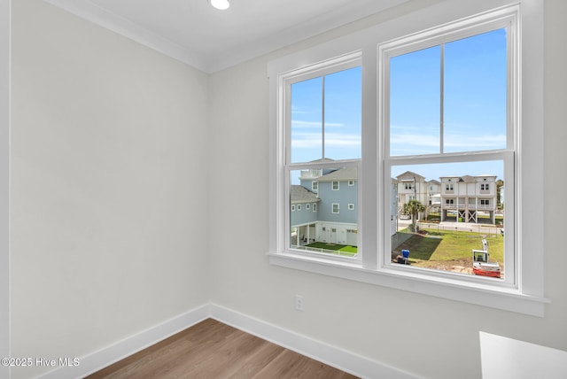 808 S 2nd St, Carolina Beach, NC 28428 - empty room with baseboards, wood finished floors, and ornamental molding