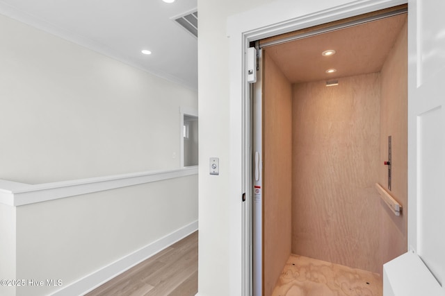 808 S 2nd St, Carolina Beach, NC 28428 - corridor featuring elevator, wood finished floors, recessed lighting, ornamental molding, and baseboards